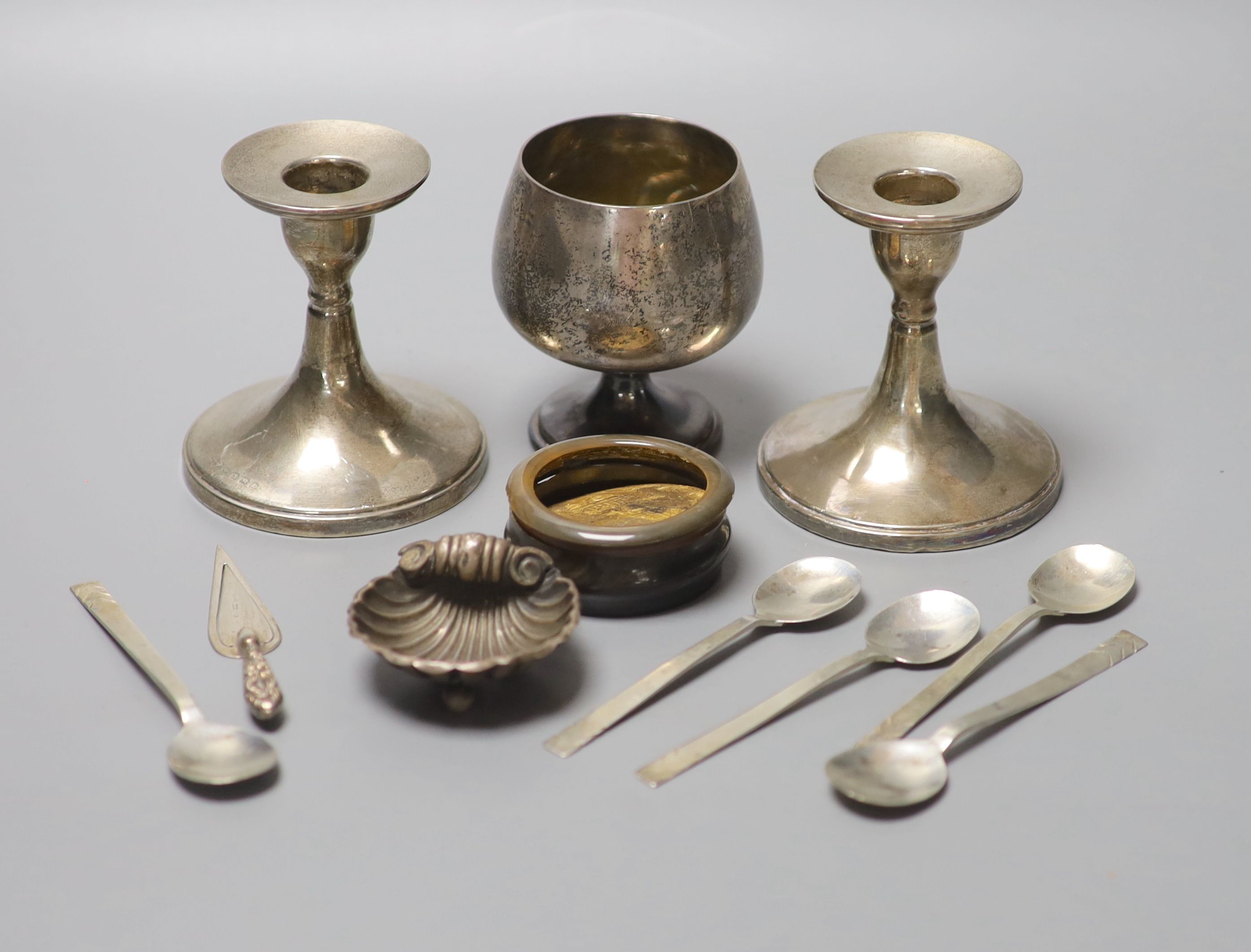 A group of small silver including dwarf candlesticks, coffee spoons, vesta, goblet, bookmark etc. and a horn box.